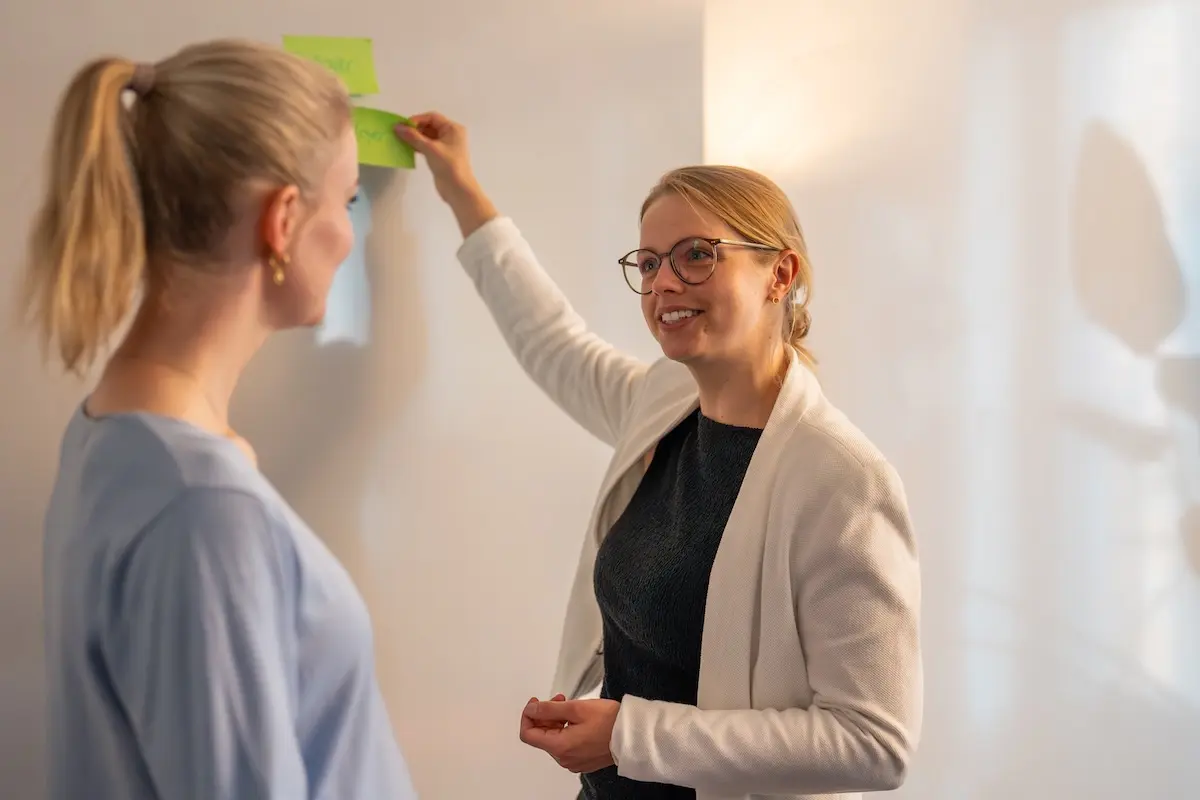 Anne Kritter gibt Schulung in Burnout-Prävention mit Post-its auf Whiteboard